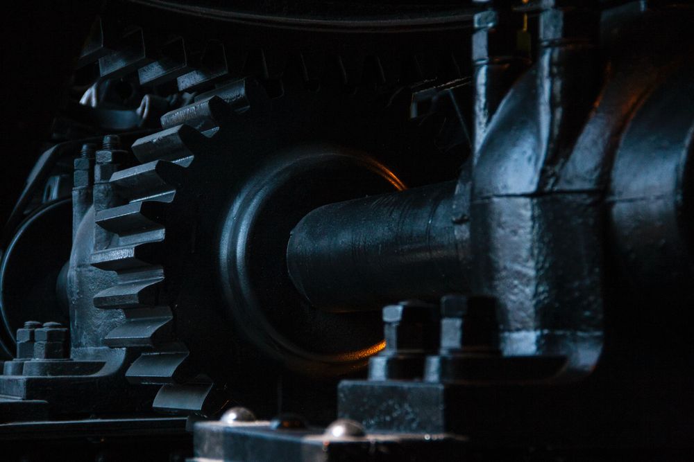 The metal gears and cogs of a large machine.